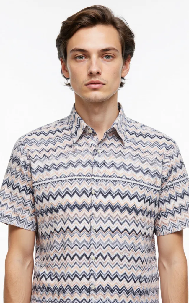 A French model wearing a Zigzag pattern   printed shirt, against a white background, in a front   facing bust portrait